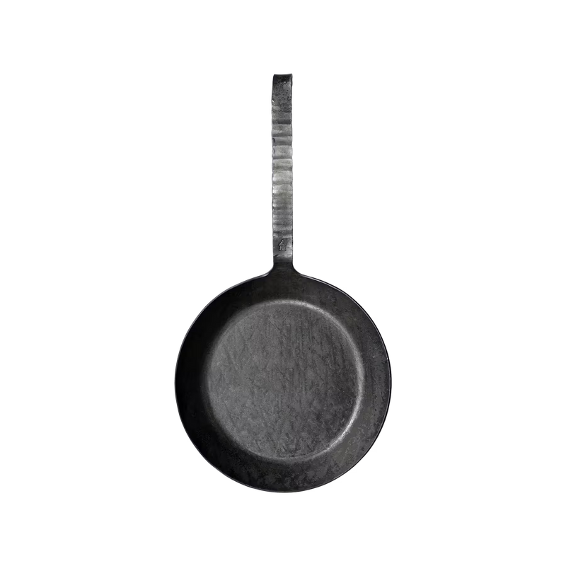 Eine schwarze, runde Bratpfanne aus Metall mit einem langen, strukturierten Griff, von oben gesehen auf einem schlichten weißen Hintergrund. Die Pfanne weist Gebrauchsspuren mit sichtbaren Kratzern auf.